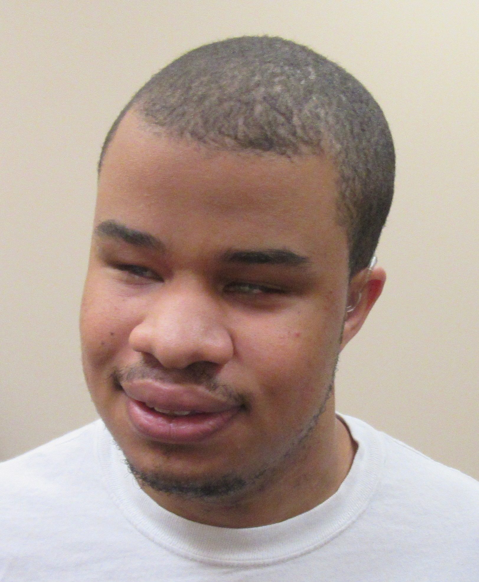 A young man with very short black hair.