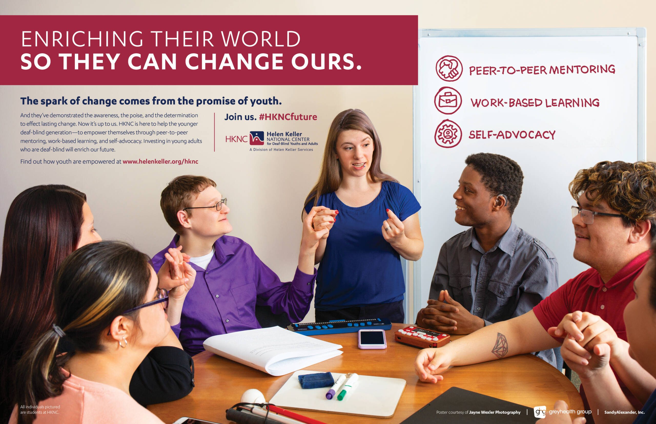 A poster with heading “Enriching Their World So They Can Change Ours”. A young woman is standing signing to five young men and women sitting around a table.
