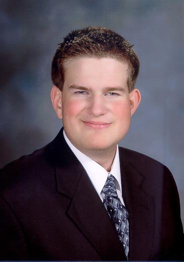 Jon Gabry smiling and wearing a suit and tie