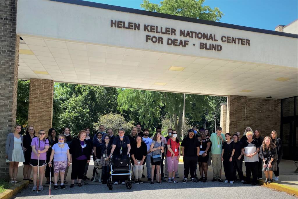 Group of individuals in front of the HKNC building.