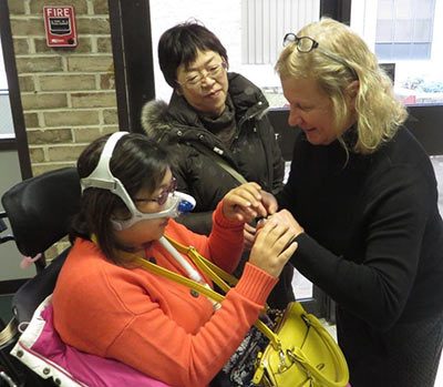 Sue Ruzenski conversing with Akiko while her interpreter looks at them