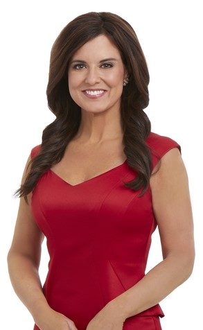 Amy Freeze smiling into the camera and wearing a fancy red shirt