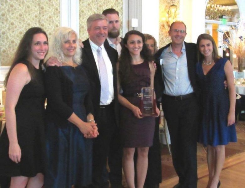 A group of men and women wearing formal attire at a Gala