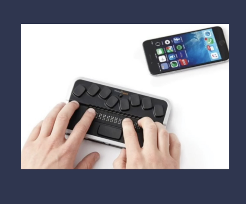 Person using a braille display and iPhone