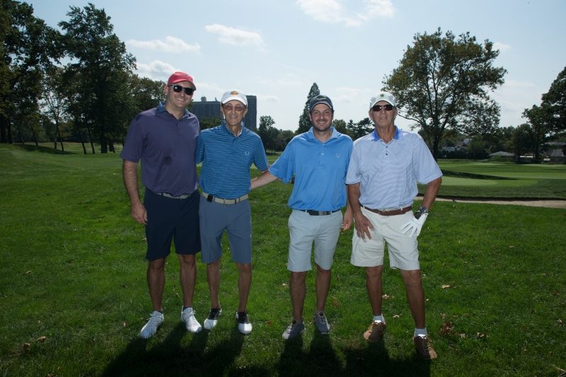 Four men on a golf course.