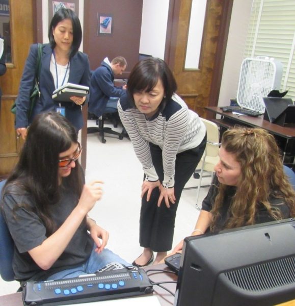 Group of women looking at a braille display
