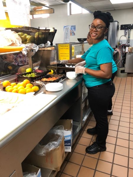 Isatou at work in a kitchen