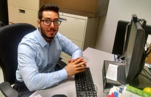 A man named Hussein sitting at a desk