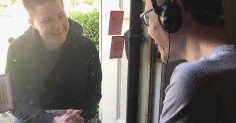 Corrine teaching a participant through a glass door