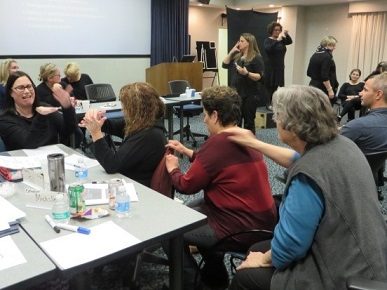 Group of people using touch signals while sitting in the HKNC conference center