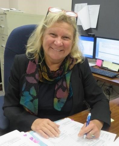 Sue Ruzenski smiling at her desk