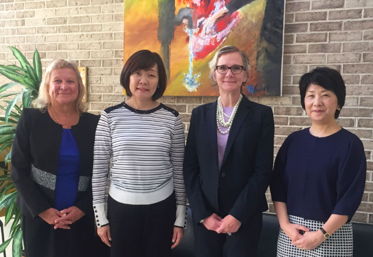 Mrs. Akie Abe standing next to 3 women