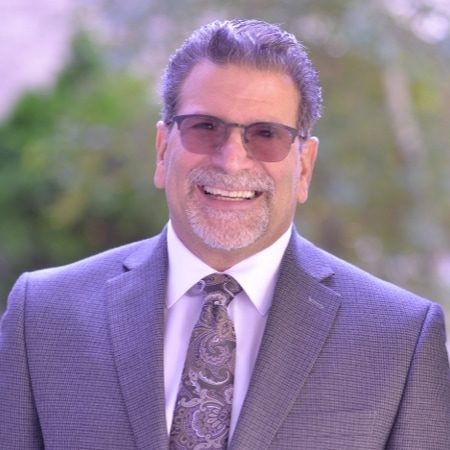 Gary Messina standing outside and smiling into the camera