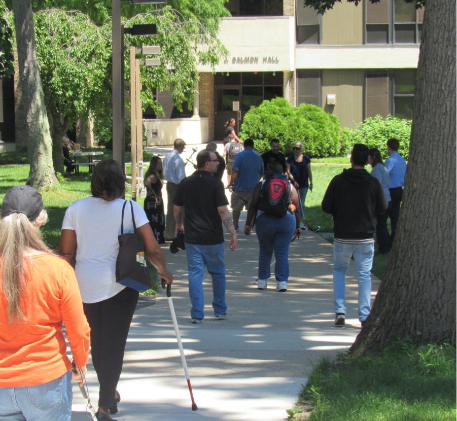 Group of people walking outside toward Peter & Salmon Hall at Helen Keller Services headquarters