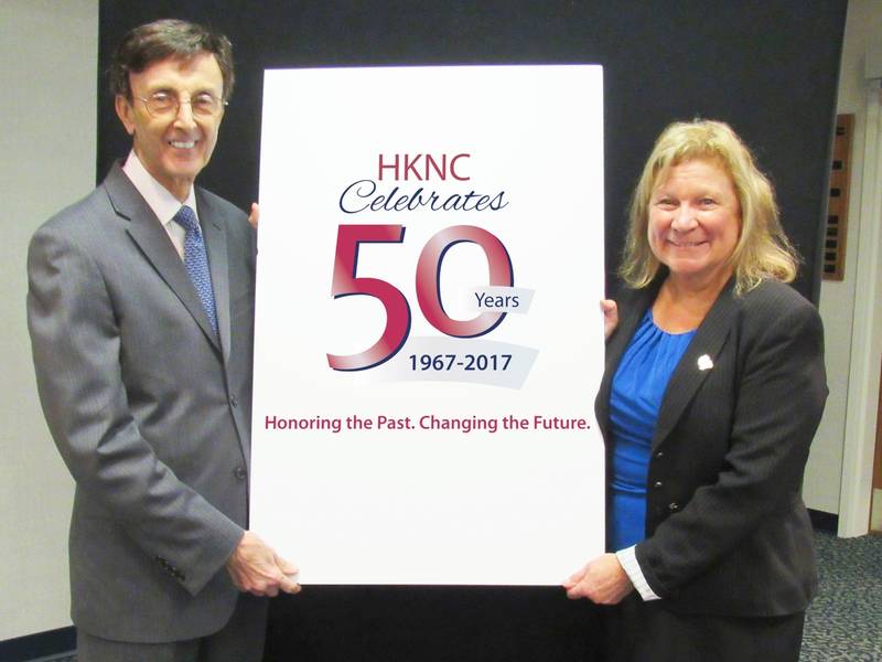 A man and a woman holding a sign that says HKNC Celebrates 50 Years