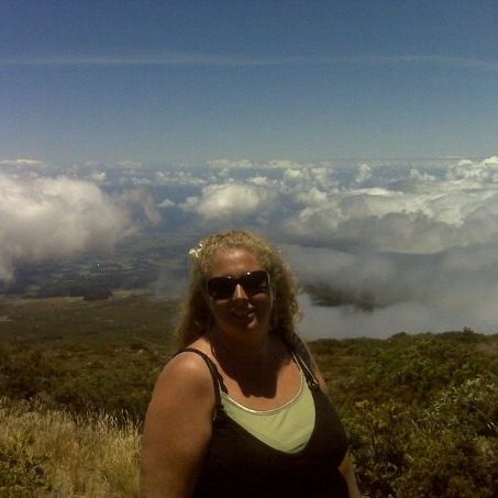 Women standing in front of landscape of woman and clouds