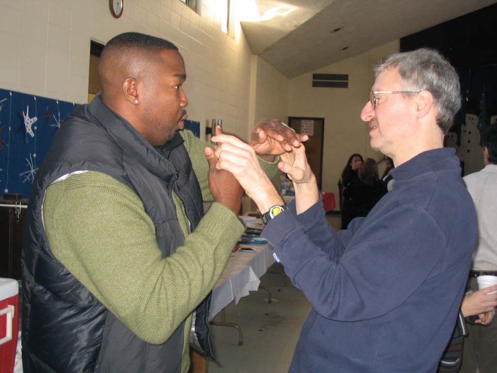 Two men touching each other’s hands