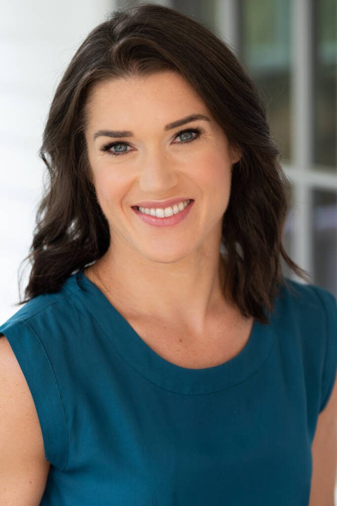 Rebecca Alexander smiling into the camera and wearing a blue shirt