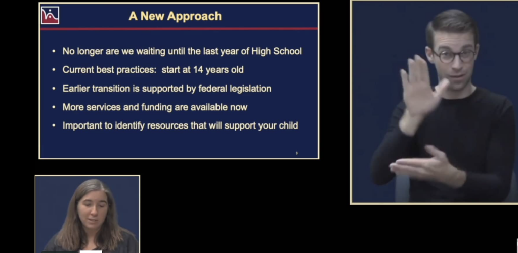 A man signing and a woman on a screen with a presentation page that says A New Approach on it