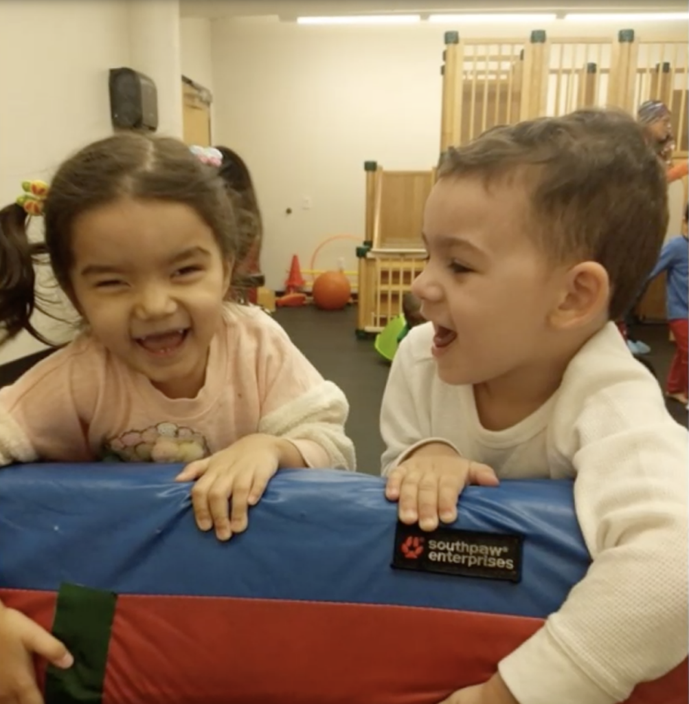 A young girl and young boy smiling