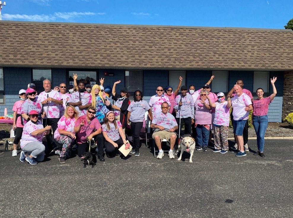 Group of people outside wearing Breast Cancer Walk shirts