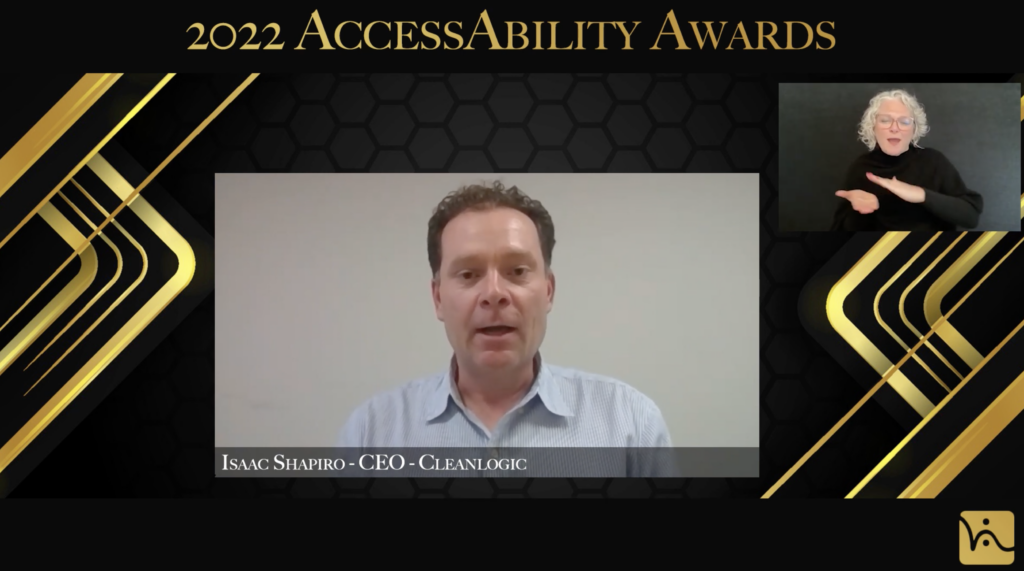 Man looking into camera. Text on top of image says “2022 AccessAbility Awards”