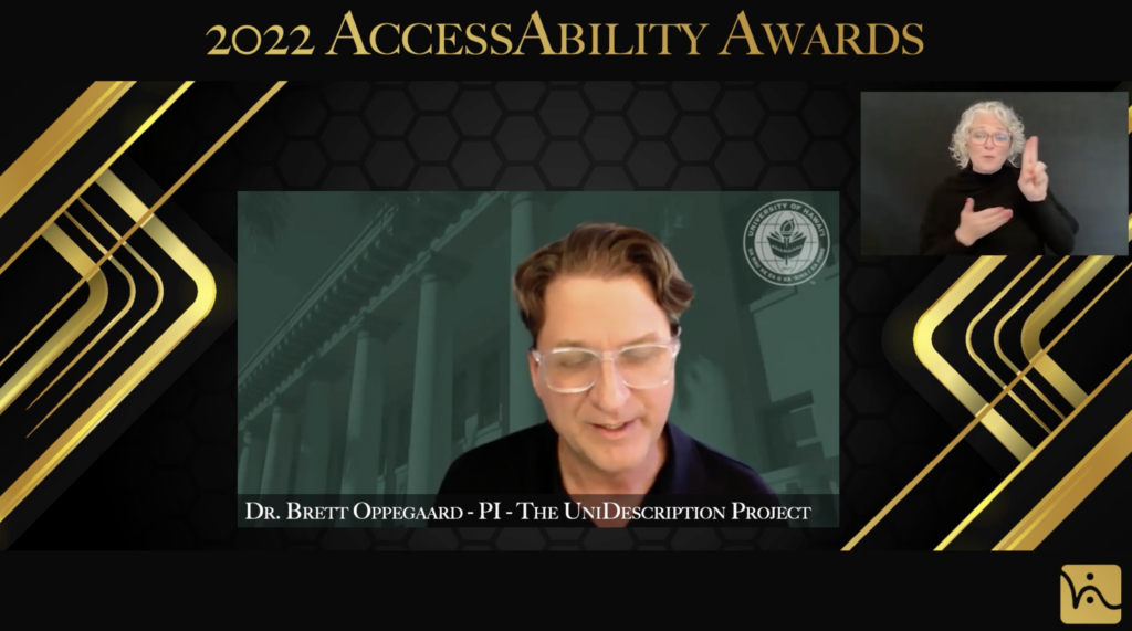 Man looking down and woman signing. Text on top of image says “2022 AccessAbility Awards”