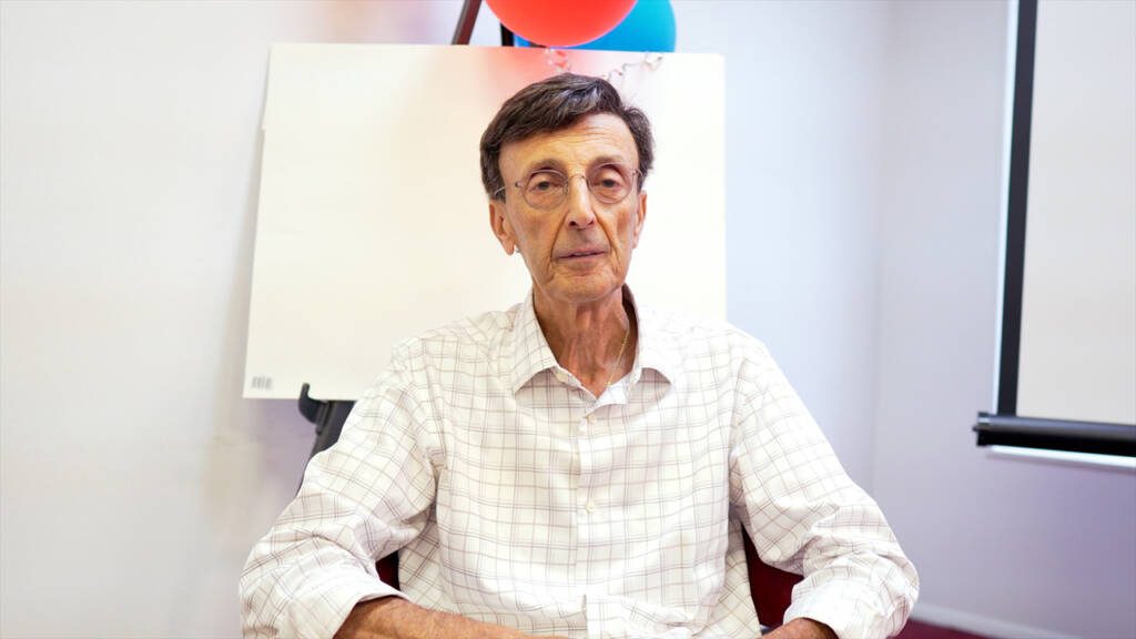 Man wearing glasses and a collared shirt