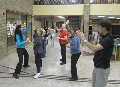 Group of women dancing inside campus building