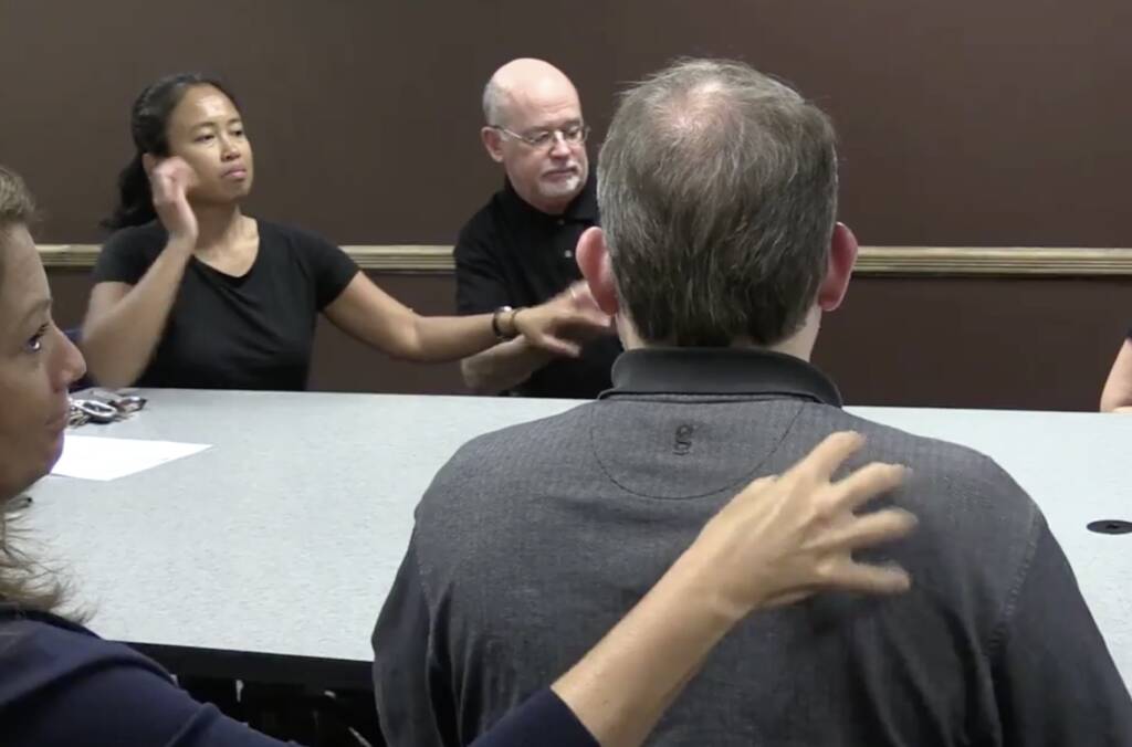 A woman touching a man's back