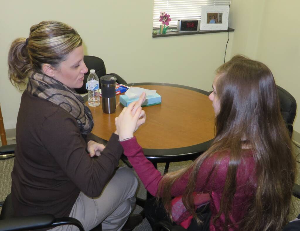 A woman and girl doing tactile sign