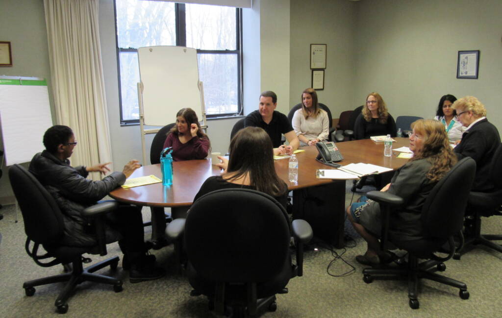 Group of people sitting around a conference table