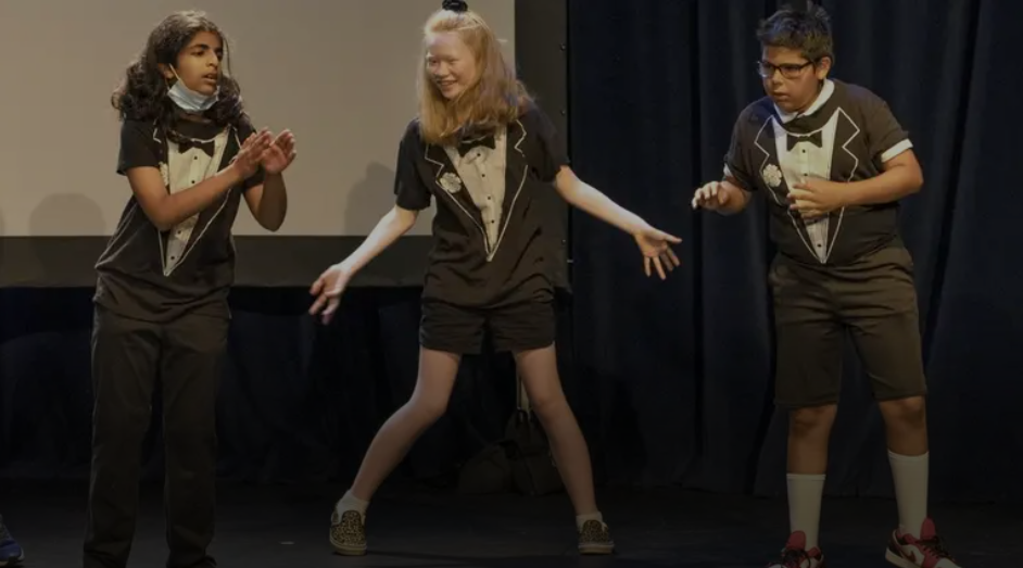 3 campers wearing tuxedo shirts on stage