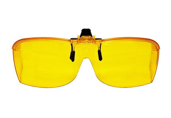 A bright yellow filter that clips onto glasses