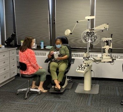 Two women in a room with vision equipment