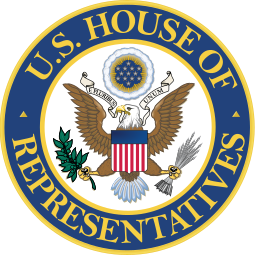The US House of Representatives' Seal of the House. It is circular and in the middle of it is an eagle with outstretched wings and a flag with 13 red and white stripes on it