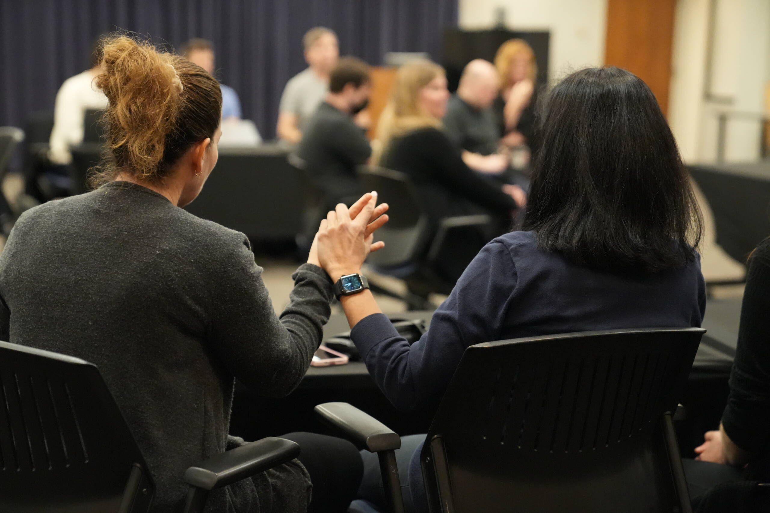 Two woman touching hands and communicating in tactile sign language