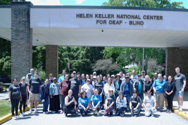 deloitte-1 A group of Deloitte volunteers standing together with staff and participants at Helen Keller National Center.