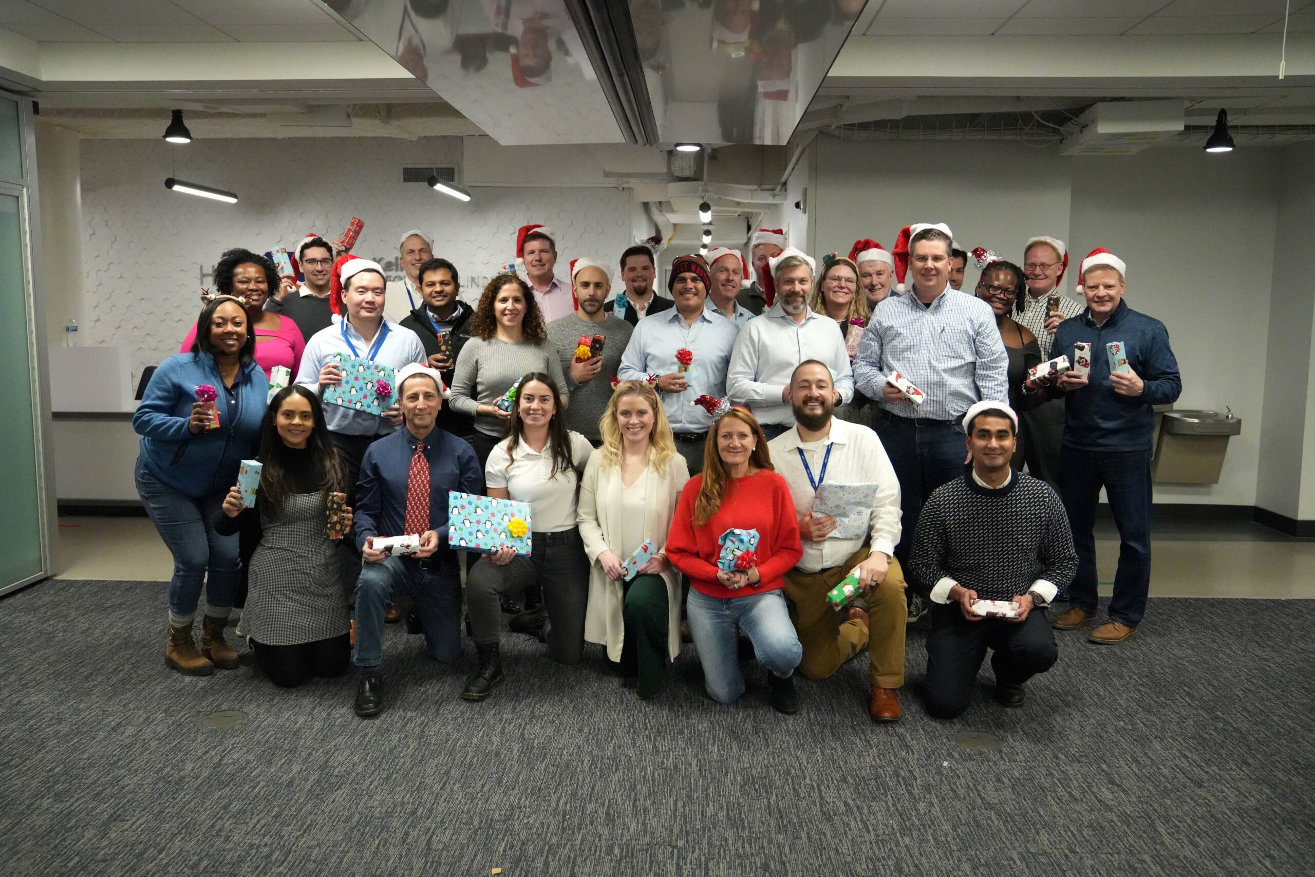 A group photo of National Grid employees during a holiday gift donation and wrapping event.  