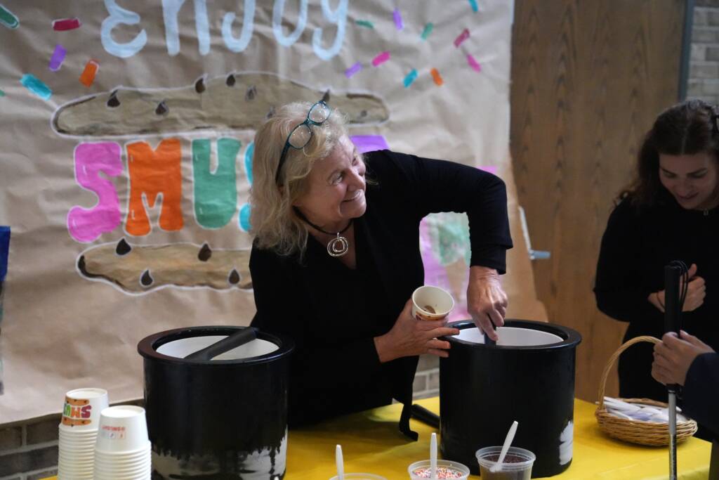 Helen Keller Services CEO Sue Ruzenski scoops ice cream during the Tech Blitz event.
