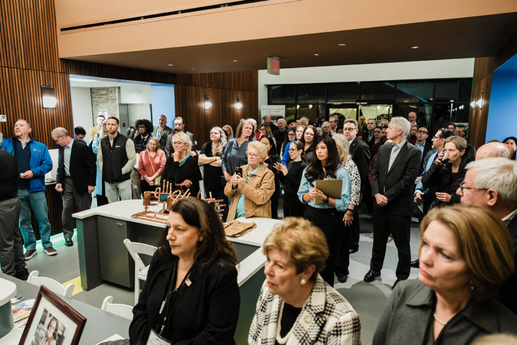 Approximately 100 attendees assembled in the atrium.