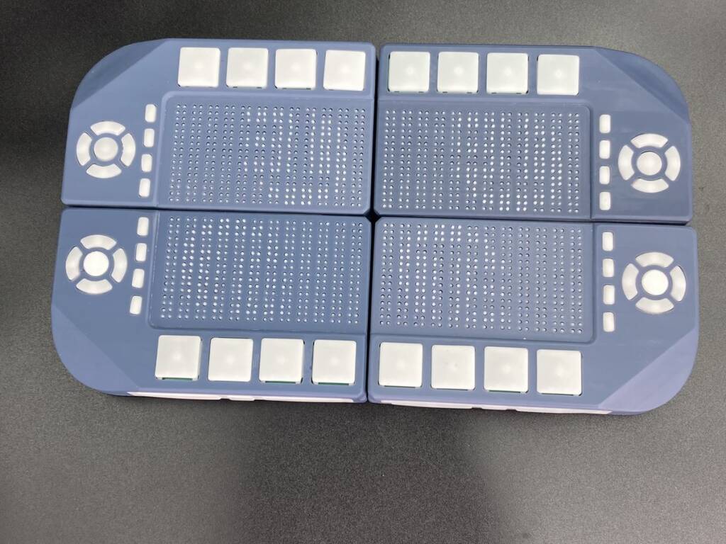 Four Tactile Engineering Cadence Pocket units combined into the Workstation configuration, forming eight lines of braille cells with directional pads and buttons at the outer edges.