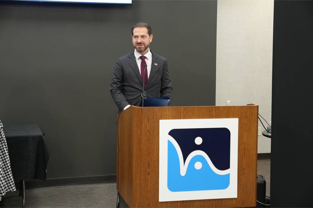 NYS Assemblyman Daniel Norber speaks at the podium.